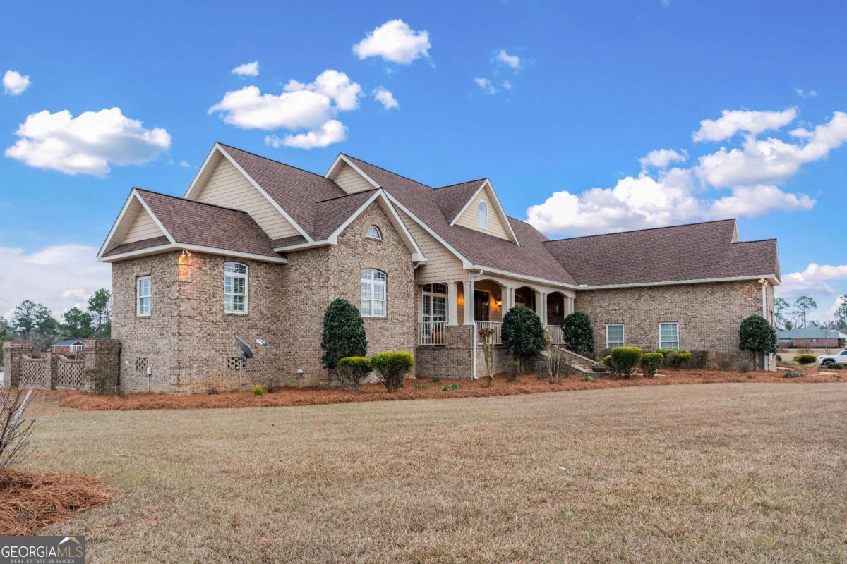 42 Claxton Road Hazlehurst, GA 31539 - Photo 15 of 73 a front view of a house with a yard and garage
