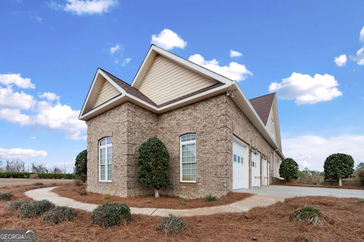 42 Claxton Road Hazlehurst, GA 31539 - Photo 17 of 73 a front view of a house with a yard and garage