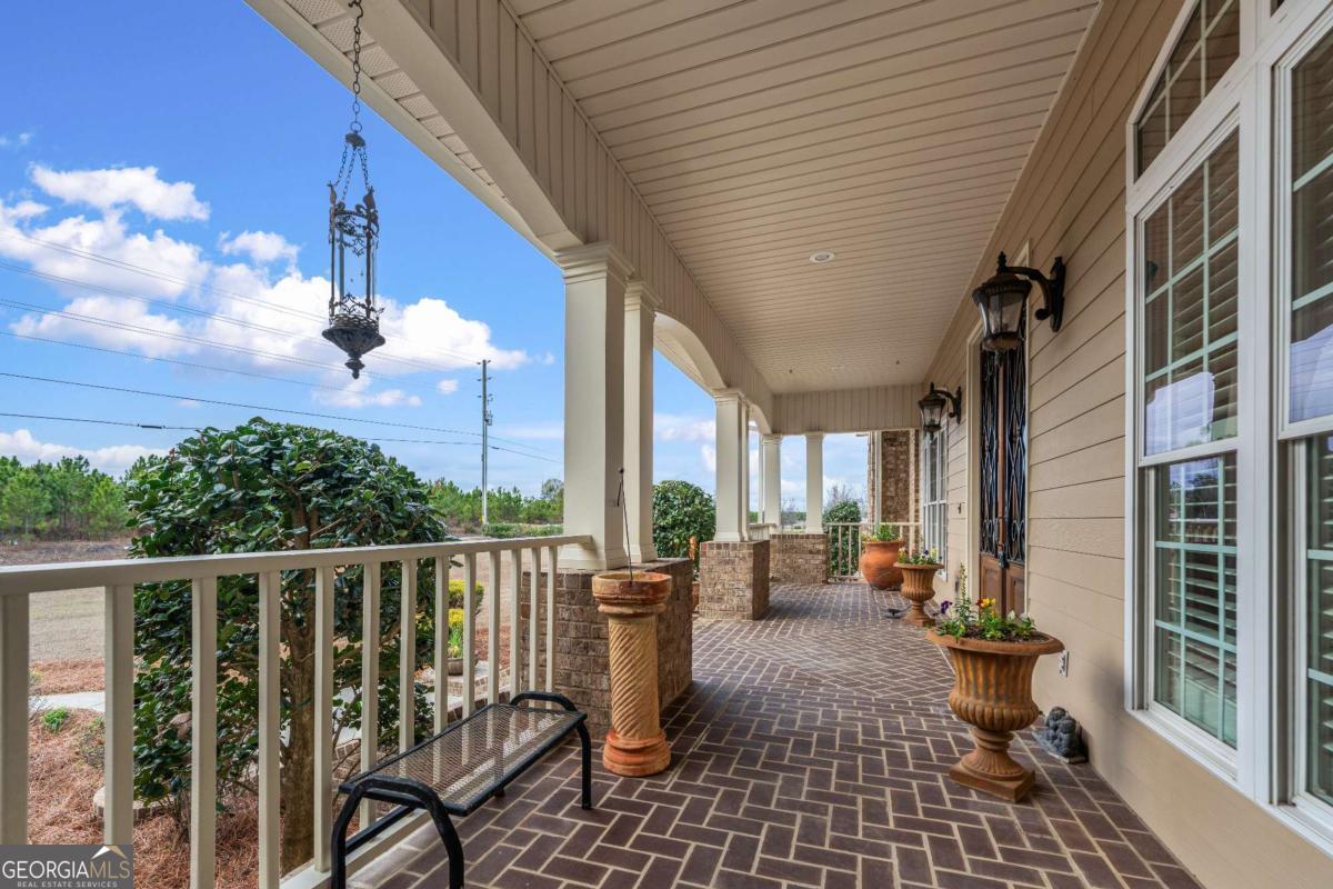 42 Claxton Road Hazlehurst, GA 31539 - Photo 26 of 73 a view of a patio with couches chairs and wooden floor