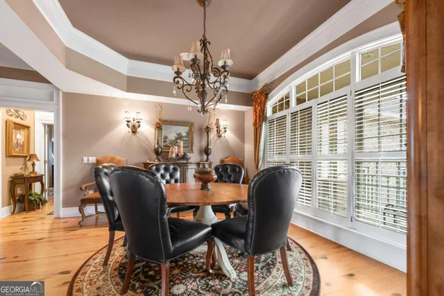 a living room with lots of furniture and a floor to ceiling window