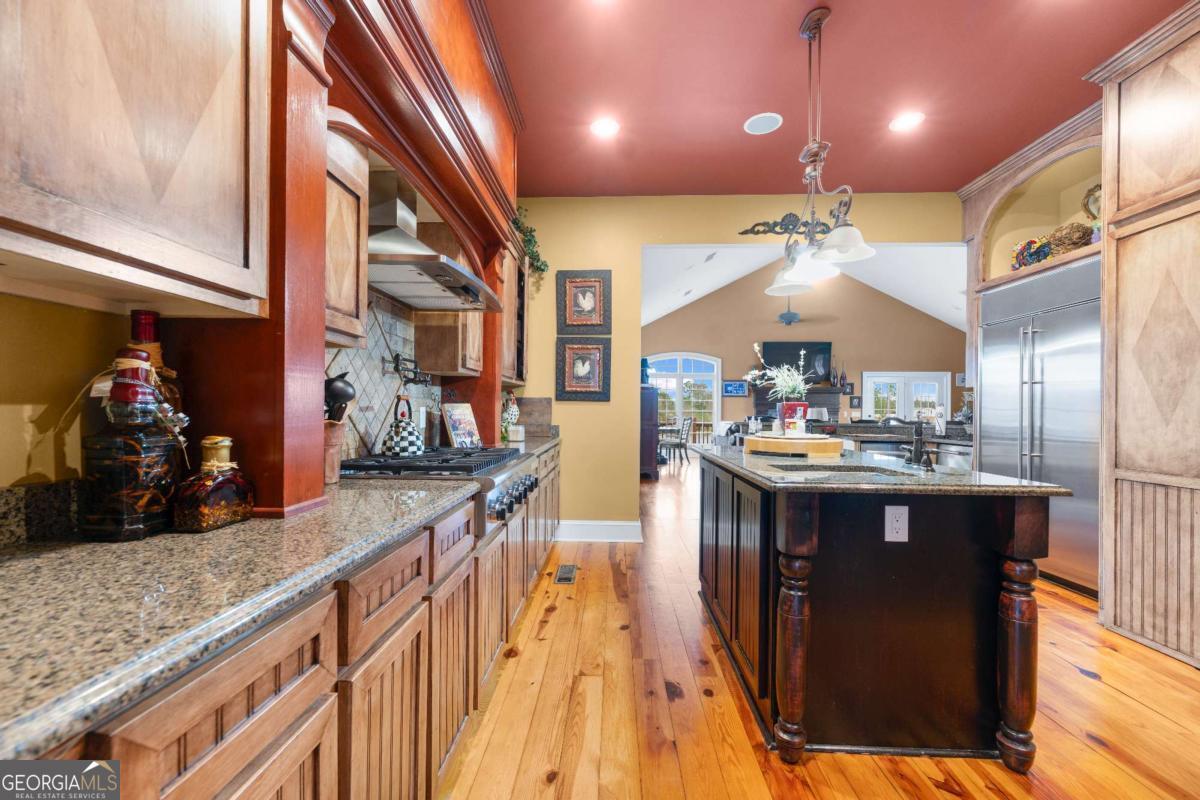 42 Claxton Road Hazlehurst, GA 31539 - Photo 42 of 73 a kitchen with stainless steel appliances granite countertop a sink a stove and a wooden floors