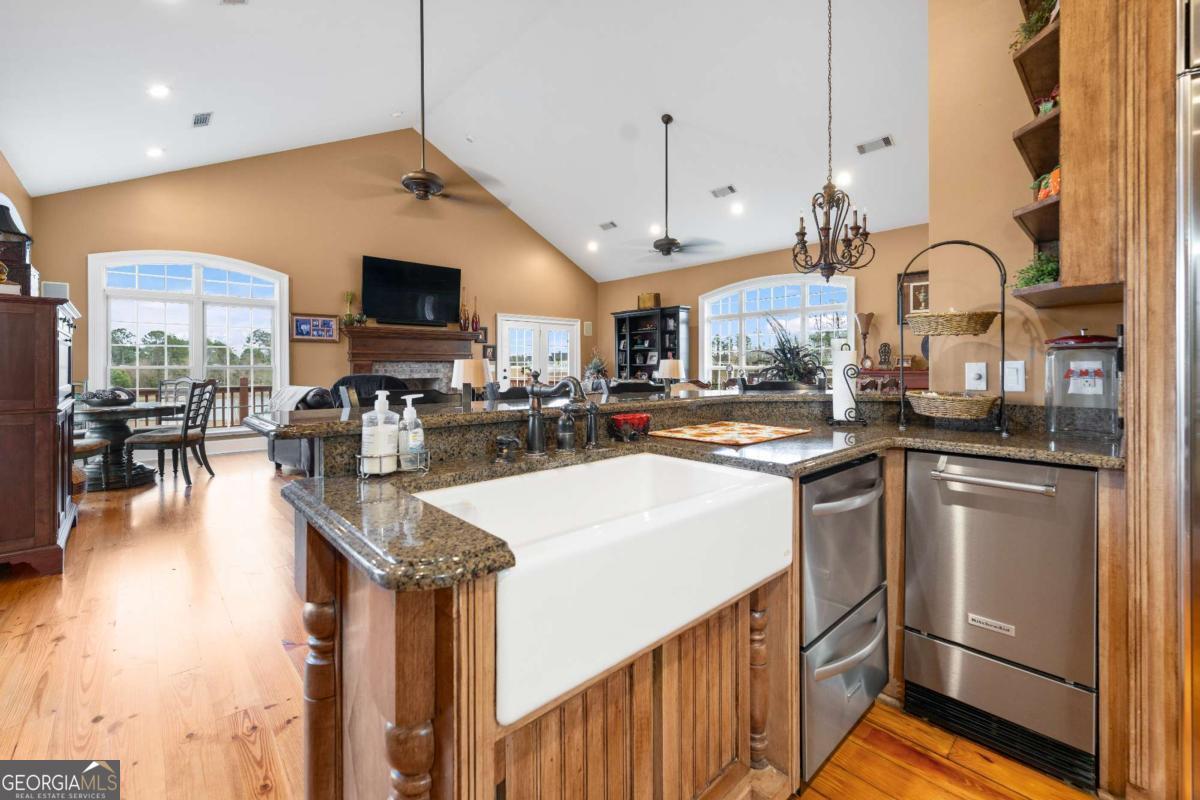 42 Claxton Road Hazlehurst, GA 31539 - Photo 43 of 73 a kitchen with stainless steel appliances granite countertop a sink a stove and a refrigerator