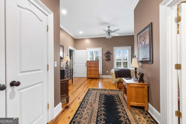 a living room with furniture and a ceiling fan