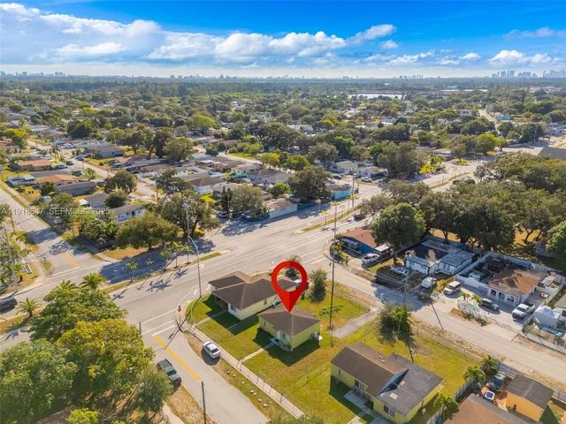 an aerial view of residential houses with outdoor space