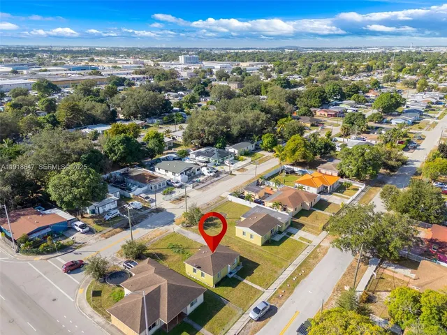 an aerial view of residential houses with outdoor space