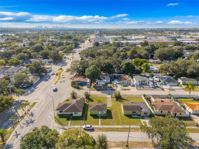 a view of a city with lots of residential buildings ocean and mountain view in back