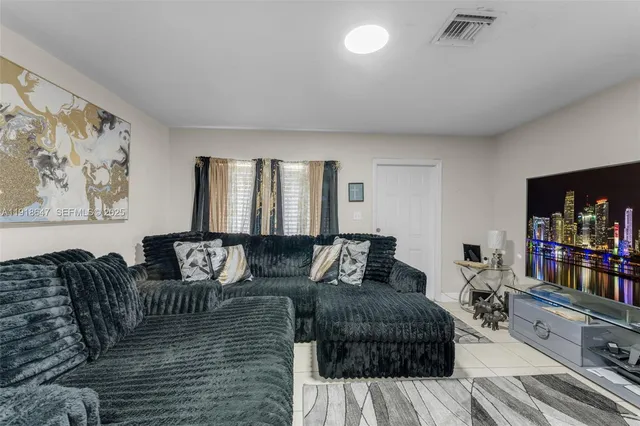 a living room with furniture a couch and a bookshelf