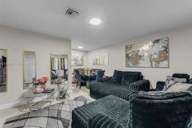 a living room with furniture kitchen and a window