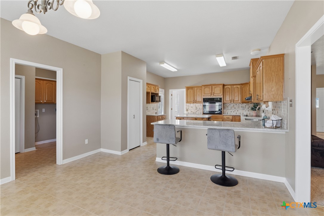 155 Guadalupe Ranch Lane Seguin, TX 78155 - Photo 20 of 48 a kitchen with stainless steel appliances kitchen island granite countertop a refrigerator and cabinets