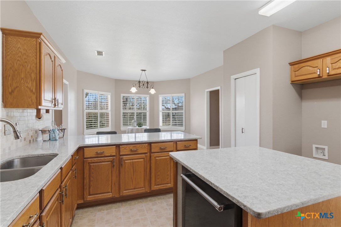 155 Guadalupe Ranch Lane Seguin, TX 78155 - Photo 23 of 48 a large kitchen with stainless steel appliances granite countertop a sink and dishwasher a stove with wooden floor