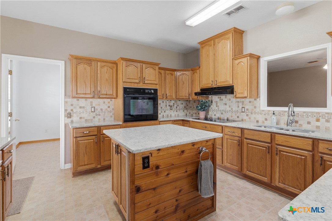155 Guadalupe Ranch Lane Seguin, TX 78155 - Photo 26 of 48 a kitchen with stainless steel appliances granite countertop a sink stove and refrigerator