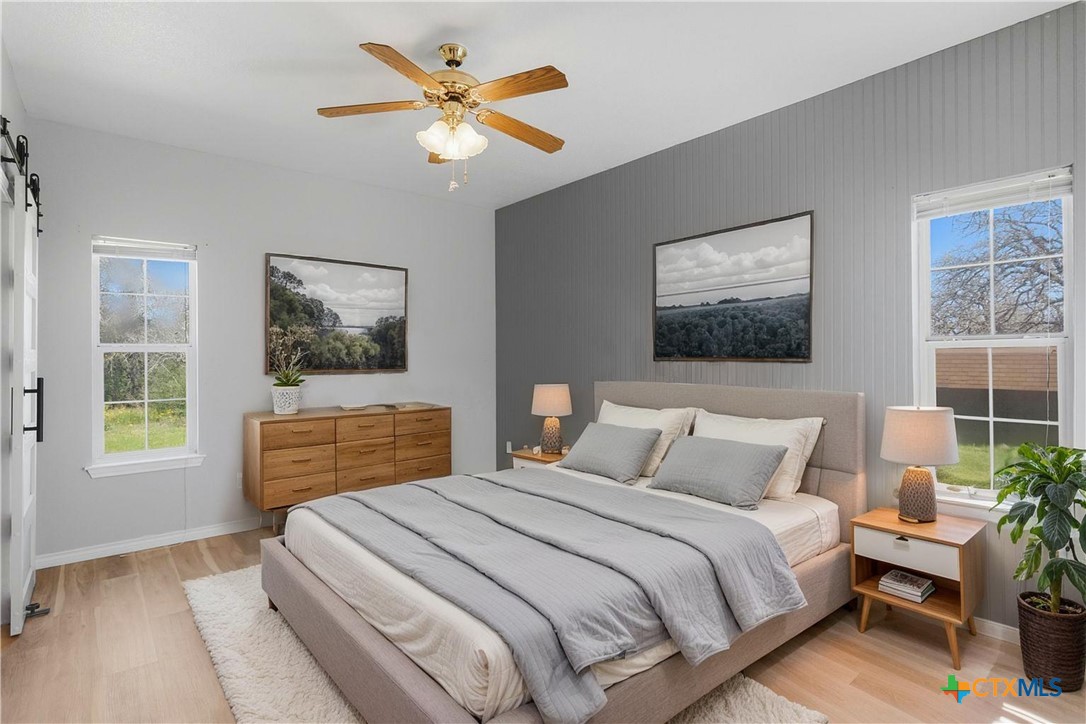 155 Guadalupe Ranch Lane Seguin, TX 78155 - Photo 28 of 48 a bedroom with a bed and a painting on the wall