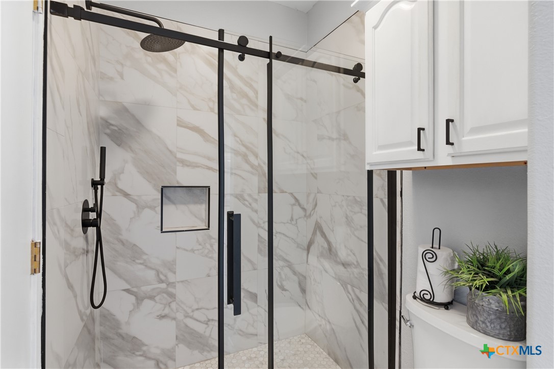 155 Guadalupe Ranch Lane Seguin, TX 78155 - Photo 31 of 48 a bathroom with a shower and a glass door shower