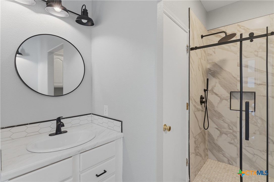 155 Guadalupe Ranch Lane Seguin, TX 78155 - Photo 32 of 48 a bathroom with a sink and a mirror