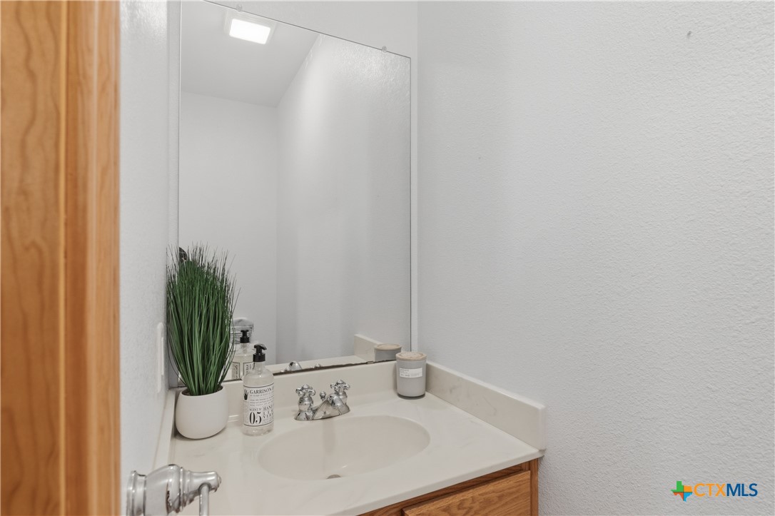 155 Guadalupe Ranch Lane Seguin, TX 78155 - Photo 39 of 48 a bathroom with a sink and a mirror
