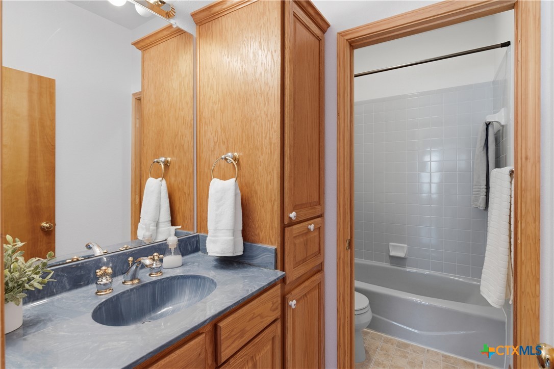 155 Guadalupe Ranch Lane Seguin, TX 78155 - Photo 43 of 48 a bathroom with a granite countertop sink and a mirror