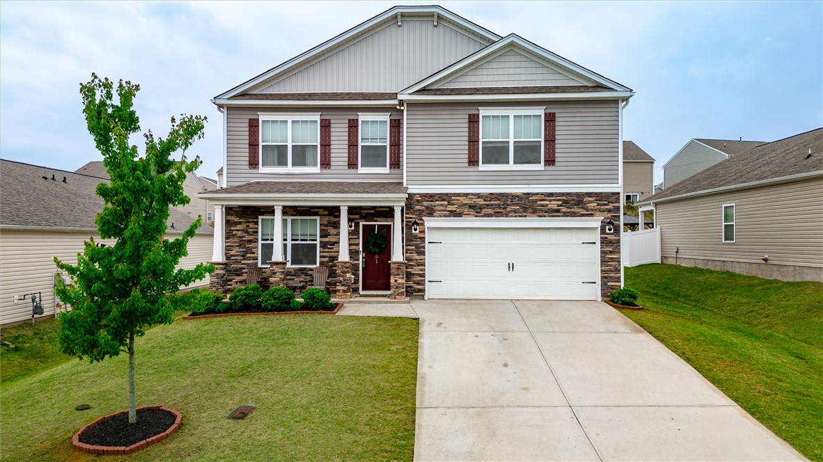 This charming residence features a well-maintained lawn and an inviting facade.