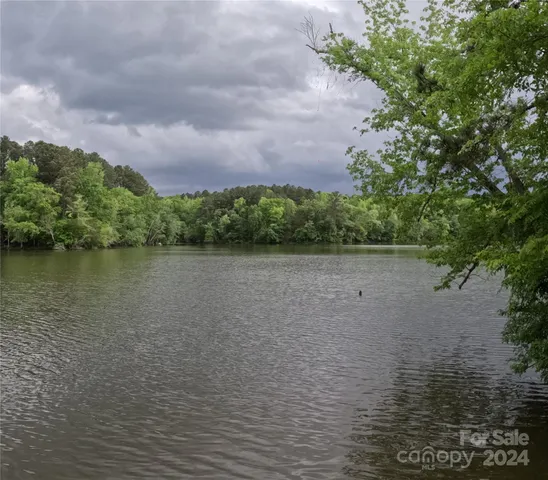 a view of a lake with houses in the back