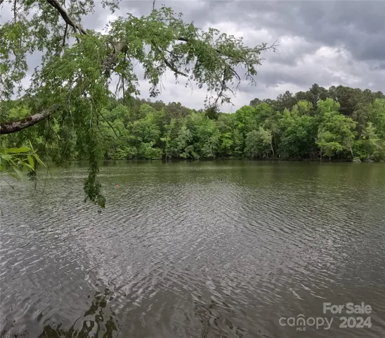 a view of a lake with houses in the back