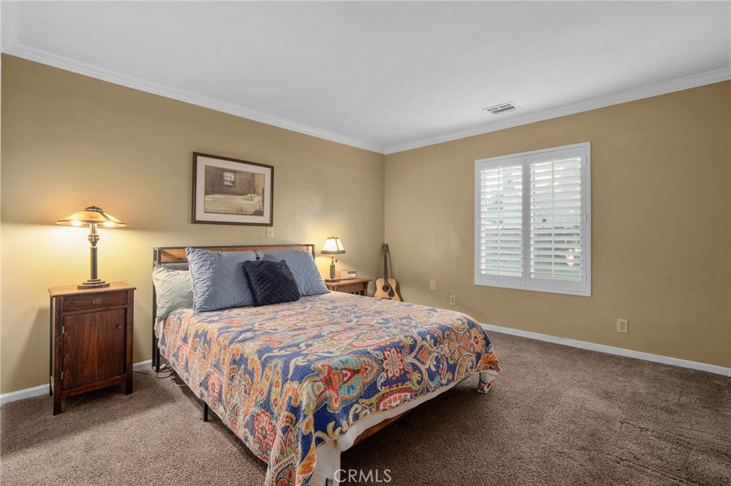 7247 Linden Lane Rancho Cucamonga, CA 91784 - Photo 19 of 51 a bedroom with a bed lamp and a window