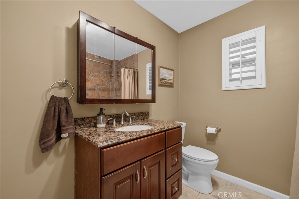 7247 Linden Lane Rancho Cucamonga, CA 91784 - Photo 23 of 51 a bathroom with a toilet sink and mirror