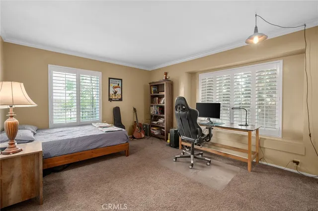 a bedroom with bed and a window