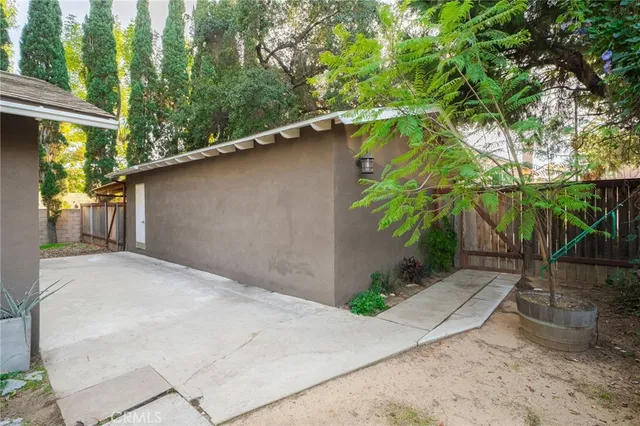 a backyard of a house with plants and trees