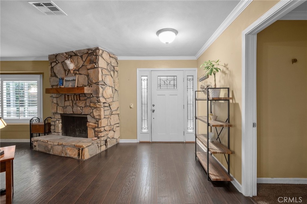 7247 Linden Lane Rancho Cucamonga, CA 91784 - Photo 6 of 51 an empty room with wooden floor fireplace and windows