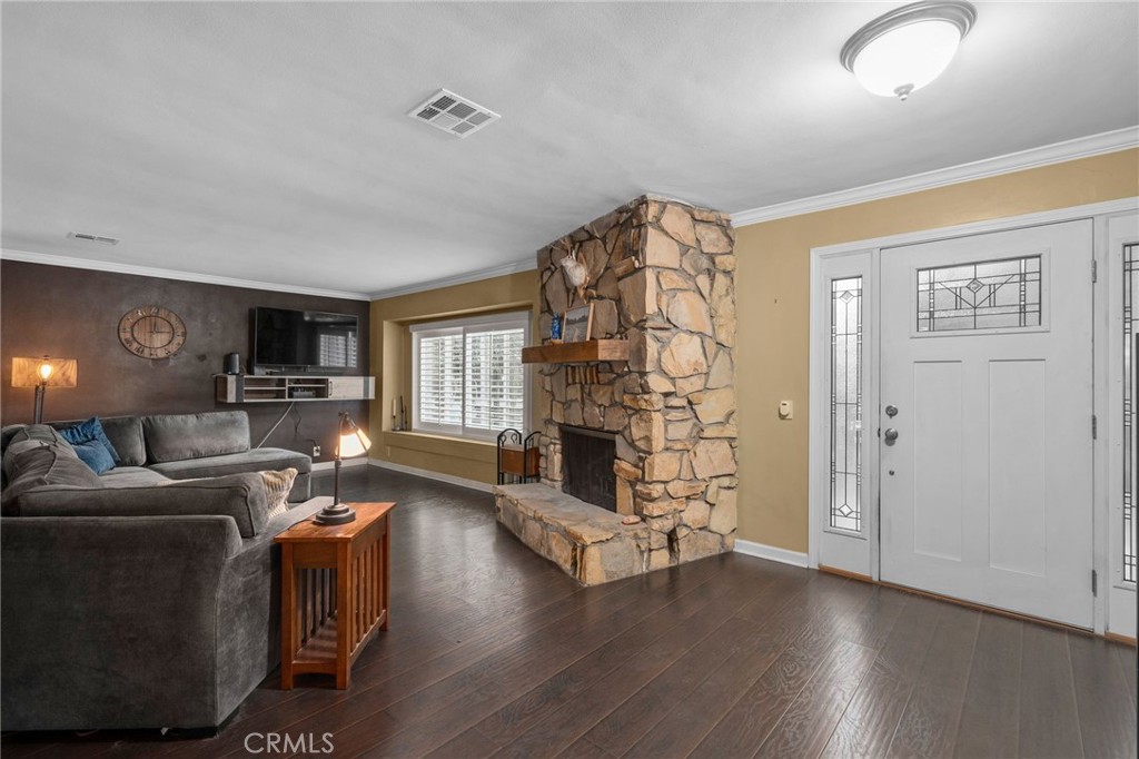 7247 Linden Lane Rancho Cucamonga, CA 91784 - Photo 8 of 51 a living room with furniture a fireplace and a flat screen tv