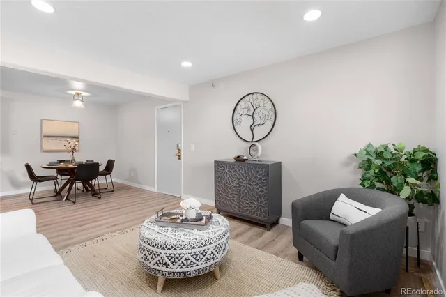 a living room with furniture and a clock