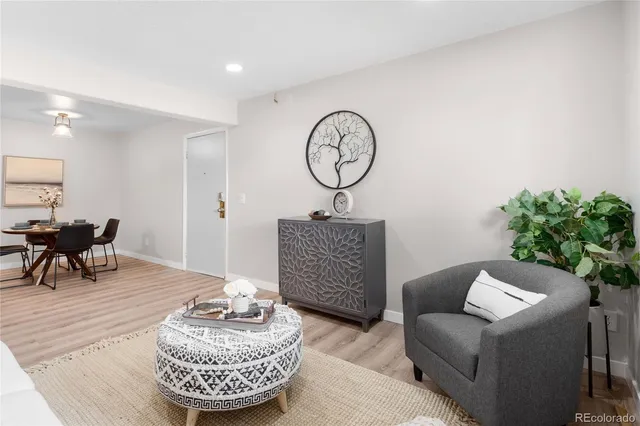 a living room with furniture and a wall painting