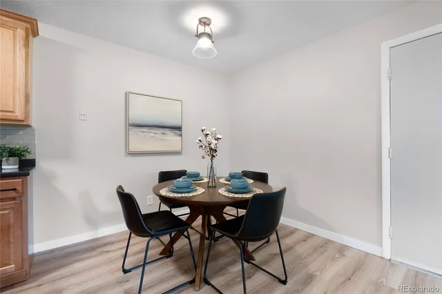 a dining room with furniture and wooden floor