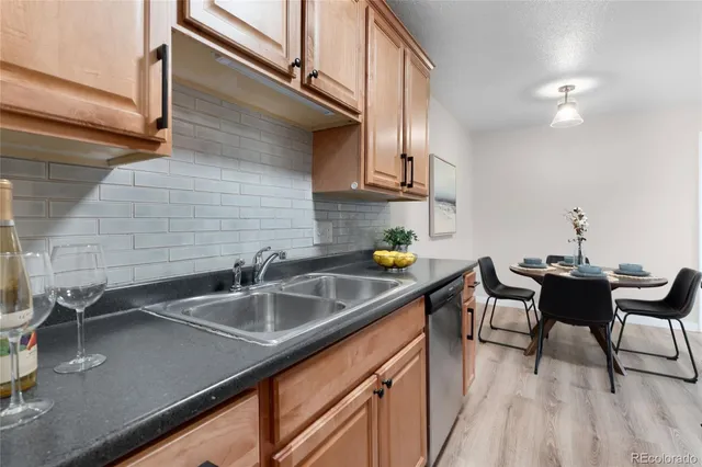 a kitchen with a sink cabinets and wooden floor