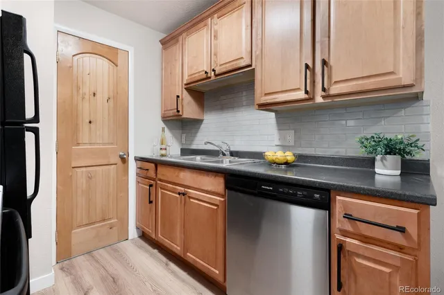 a kitchen with stainless steel appliances granite countertop a refrigerator and a sink