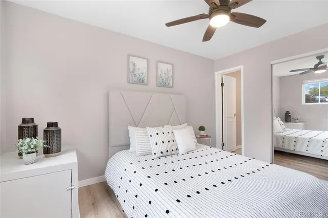 a bedroom with a bed and wooden floor