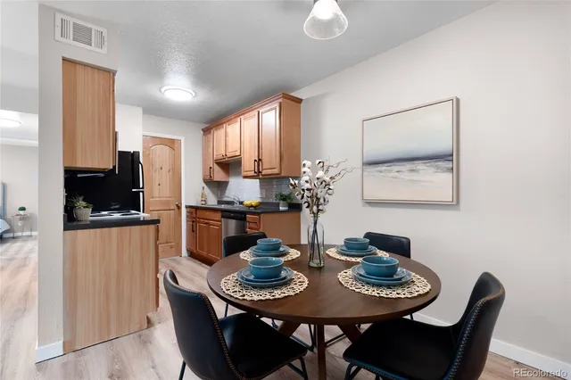 a kitchen with a dining table and chairs