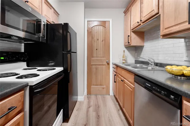 a kitchen with stainless steel appliances a sink stove and refrigerator