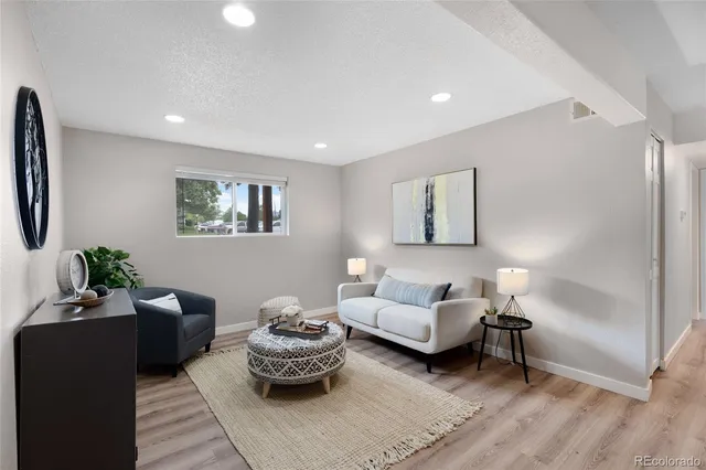 a living room with furniture and a lamp