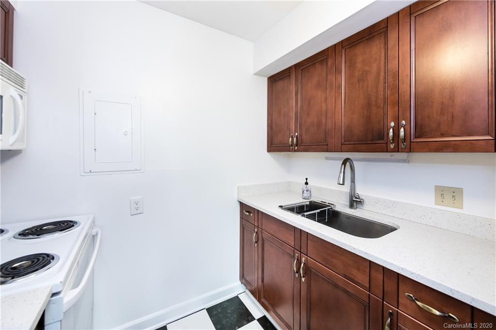 400 Queens Road, Unit D1 Charlotte, NC 28207 - Photo 12 of 23 a kitchen with a sink and cabinets