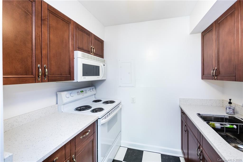 400 Queens Road, Unit D1 Charlotte, NC 28207 - Photo 13 of 23 a kitchen with kitchen island a sink cabinets and appliances