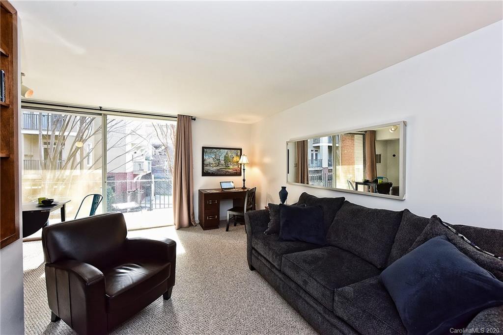 400 Queens Road, Unit D1 Charlotte, NC 28207 - Photo 7 of 23 a living room with furniture and a large window