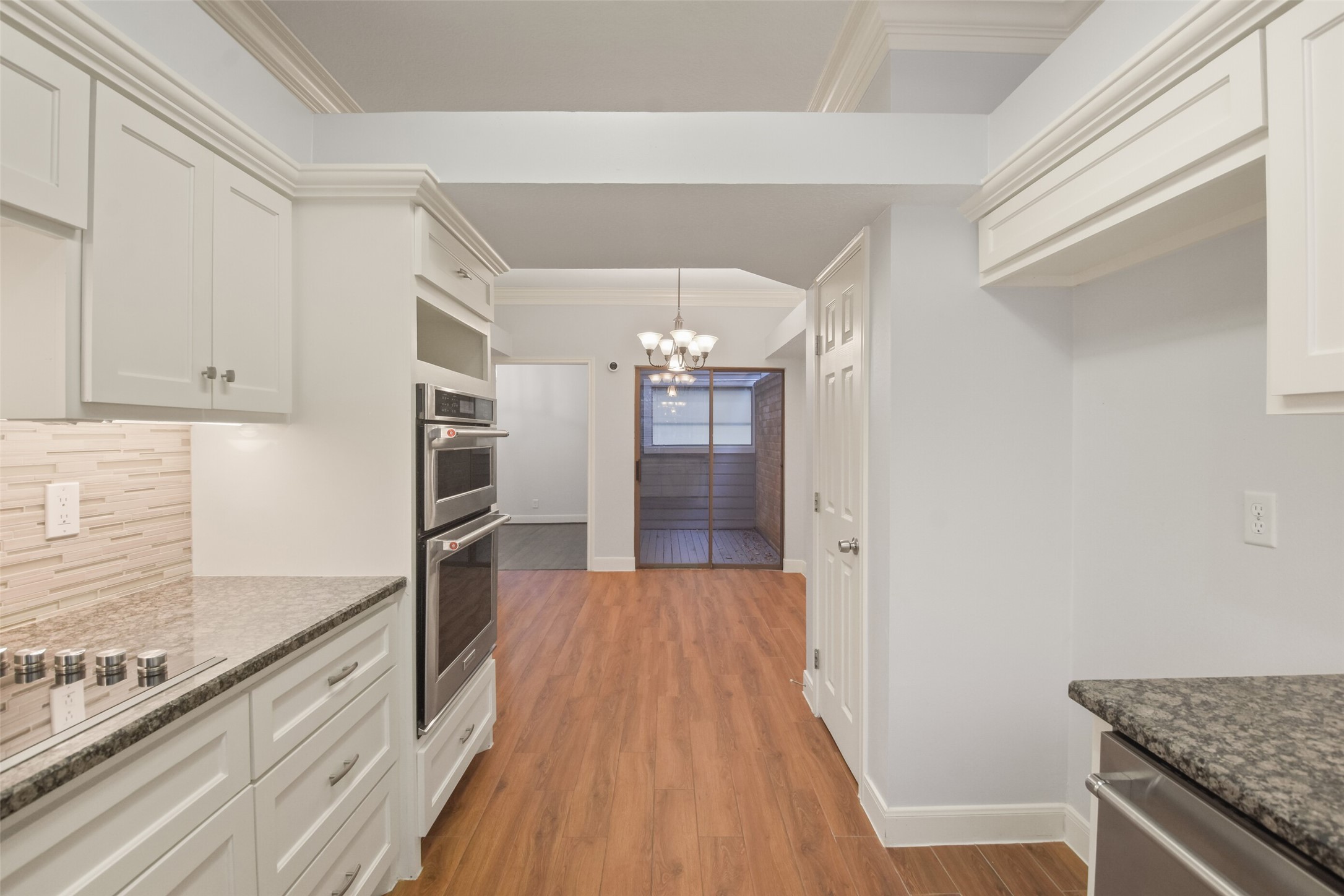 12859 Kingsbridge Lane Houston, TX 77077 - Photo 13 of 36 a view of a kitchen cabinets and wooden floor