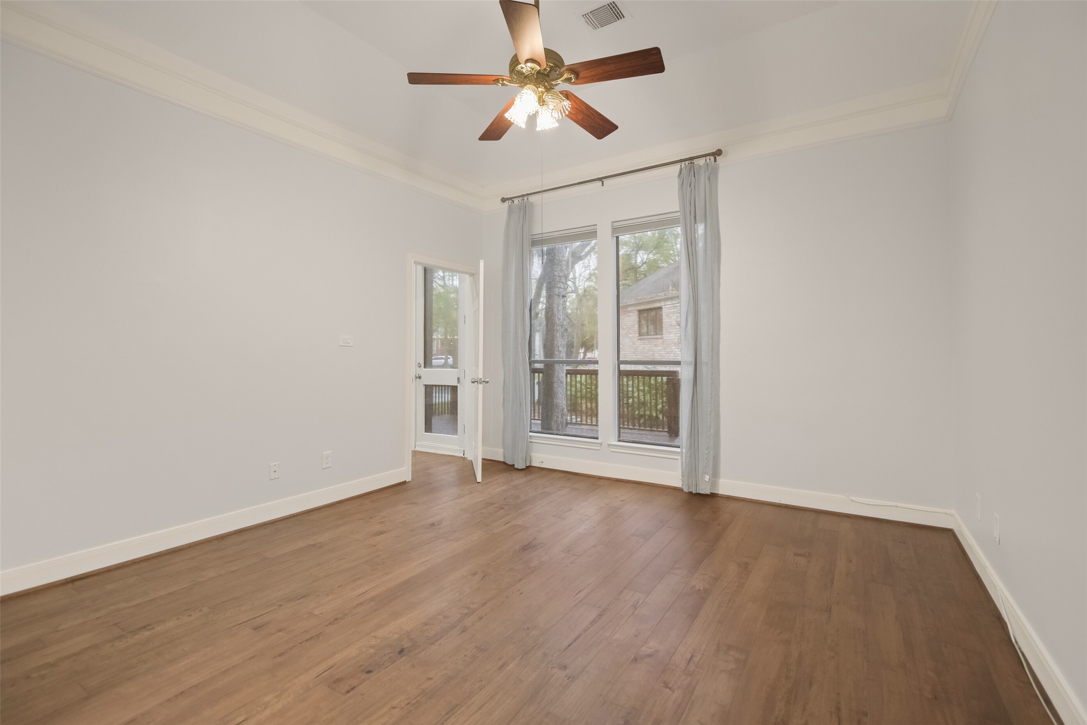 12859 Kingsbridge Lane Houston, TX 77077 - Photo 17 of 36 wooden floor in an empty room with a window