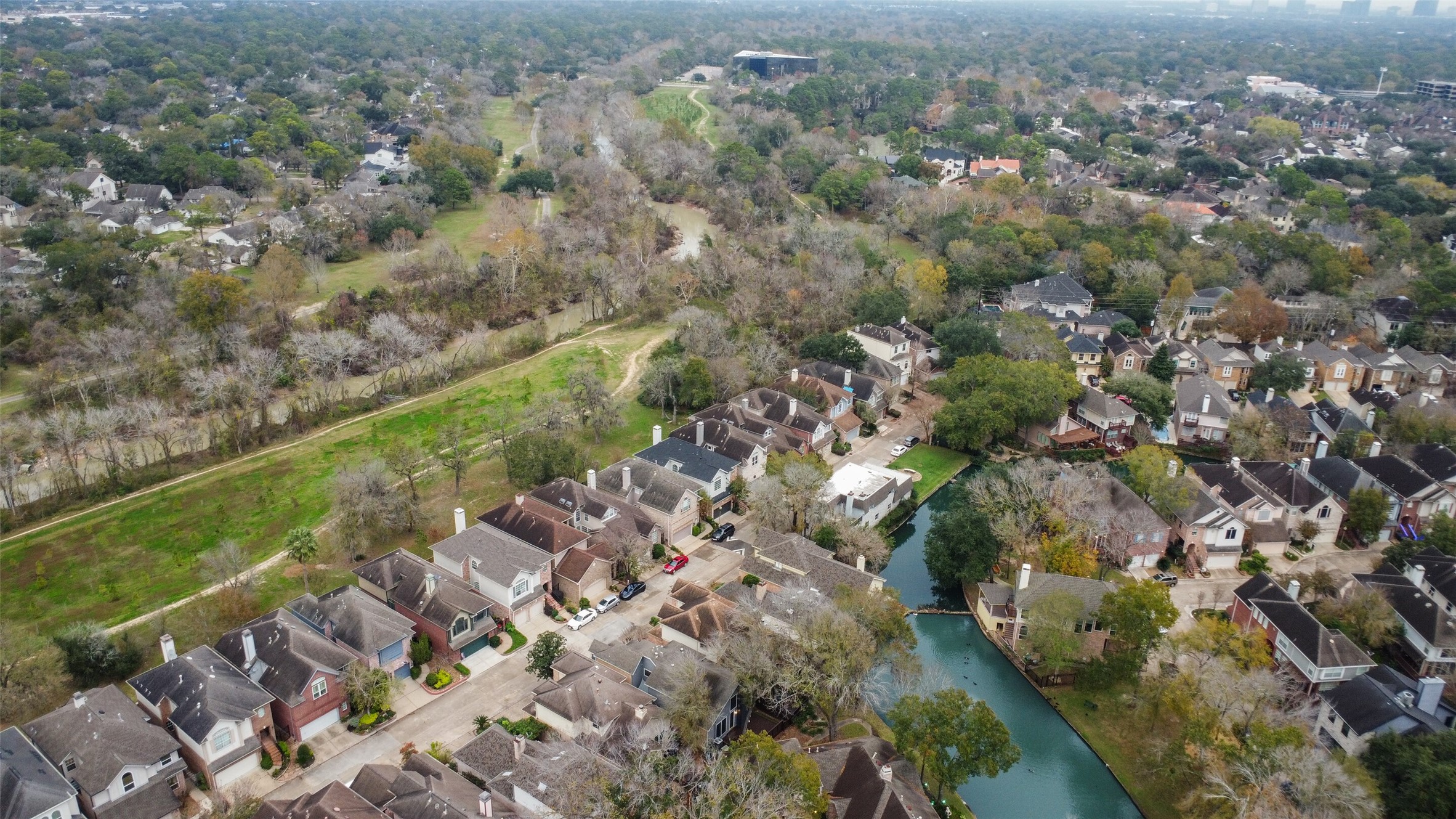 12859 Kingsbridge Lane Houston, TX 77077 - Photo 35 of 36 An aerial view of the community highlighting its seamless integration with nature, showcasing the proximity and convenient access to the renowned Terry Hershey hike and bike trail.