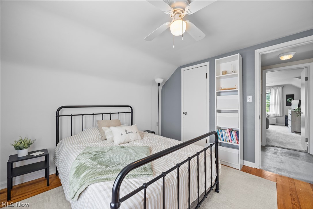 11492 Ridge Road North Royalton, OH 44133 - Photo 20 of 32 Bedroom featuring a ceiling fan with integrated lighting, hardwood flooring, and white built-in shelving