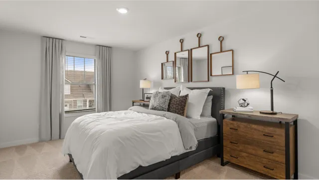 a large bed sitting in a bedroom next to a window
