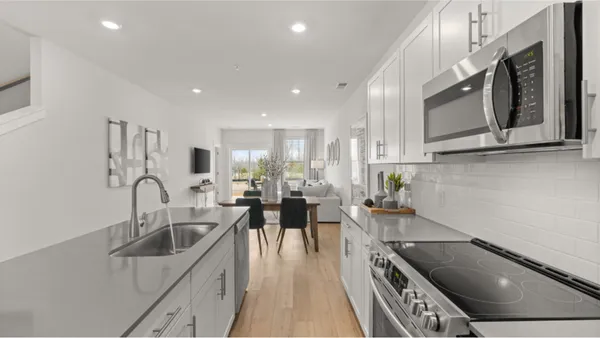 a kitchen with stainless steel appliances granite countertop a sink a stove top oven a counter space and cabinets