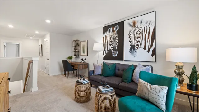 a living room with furniture and a painting on the wall