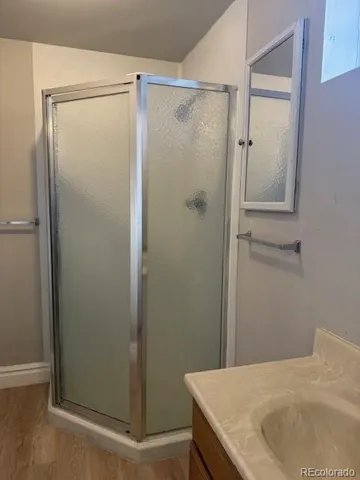 a bathroom with a glass shower door