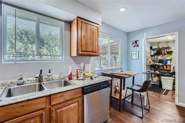 a kitchen with a sink cabinets and wooden floor